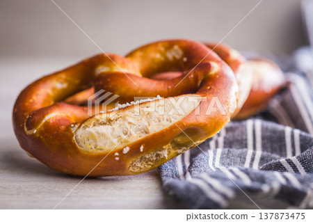 Fresh Soft Pretzels on Striped Cloth . Golden Baked Salted Snack for Breakfast or Picnic Fresh Soft Pretzels on Striped Cloth . Golden Baked Salted Snack for Breakfast or Picnic 137873475