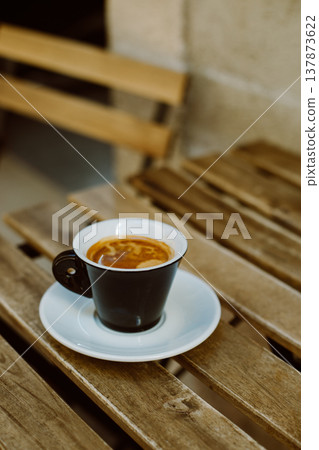 Cup of black coffee on a table in a street cafe. 137873622