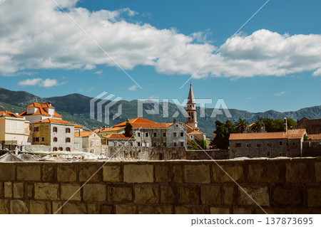 Amazing view of old Budva and St.Nicholas island and the sea near Budva. Beautiful cloudy sky. Amazing view of old Budva and St.Nicholas island and the sea near Budva. Beautiful cloudy sky. 137873695