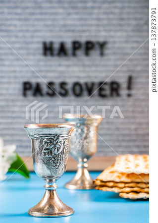 Happy Passover. Metal wine glasses and traditional Jewish matzo bread. Happy Passover. Metal wine glasses and traditional Jewish matzo bread. 137873791