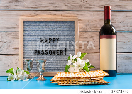 Celebrating spring holiday Passover. Bottle of wine and traditional Jewish matzo bread Celebrating spring holiday Passover. Bottle of wine and traditional Jewish matzo bread 137873792