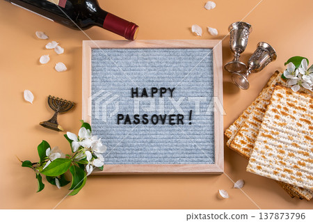 Jewish holiday Passover. Bottle of wine, spring flowers and matzo bread Jewish holiday Passover. Bottle of wine, spring flowers and matzo bread 137873796