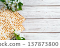 Happy Passover flatlay. Jewish matzo bread and flowers on white wooden background. 137873800