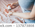 Woman is taking pills. World Health Day. Hands holding medical bottle with capsules. Health care concept. 137873808
