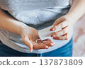 Woman is taking pills. World Health Day. Hands holding medical bottle with capsules. Health care concept. 137873809