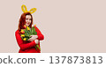 Young woman wearing bunny ears holding bouquet of tulips. Easter concept 137873813