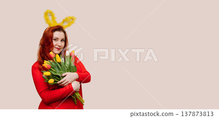 Young woman wearing bunny ears holding bouquet of tulips. Easter concept Young woman wearing bunny ears holding bouquet of tulips. Easter concept 137873813
