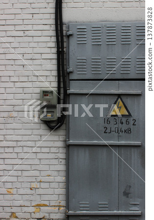 High Voltage Transformer Wall With Outdoor Electrical Panel Near Metal Door With High Voltage Risk Sign High Voltage Transformer Wall With Outdoor Electrical Panel Near Metal Door With High Voltage Risk Sign 137873828
