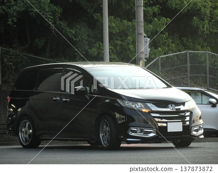 A black car parked in the parking lot A black car parked in the parking lot 137873872
