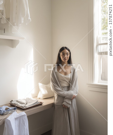 Japanese woman sitting indoors, wearing natural fashion, full outfit. 137874251