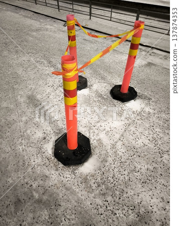 Warning barriers on ice and snow. Traffic restrictions or danger zones in winter Warning barriers on ice and snow. Traffic restrictions or danger zones in winter 137874353