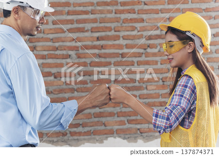 Banner Two engineer women businessman look at blueprint architecture building contractor. Team Engineer holding project planing partner teamwork. Two woman man meeting teamwork with copy space 137874371