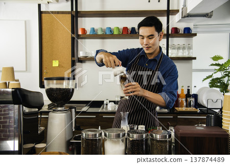 Coffee barista man make espresso shot from coffee maker hot cup. Cappuccino with milk in italian coffee shop cafe. Close up hands of barista use machine make brown latte art for customer cafeteria 137874489