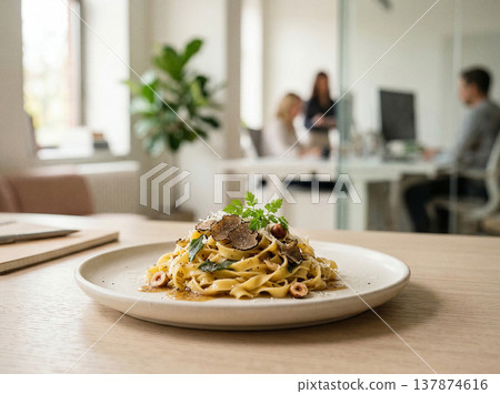 Gourmet pasta dish with truffles and herbs on a white plate in a modern office setting with fine dining Gourmet pasta dish with truffles and herbs on a white plate in a modern office setting with fine dining 137874616