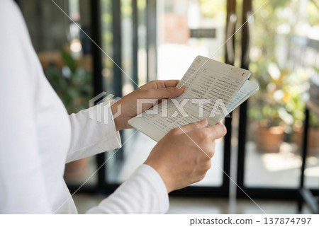 Checking a bankbook; checking savings balance; household budget management; finance; image 137874797