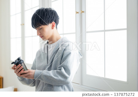 A man holding a protein shaker A man holding a protein shaker 137875272