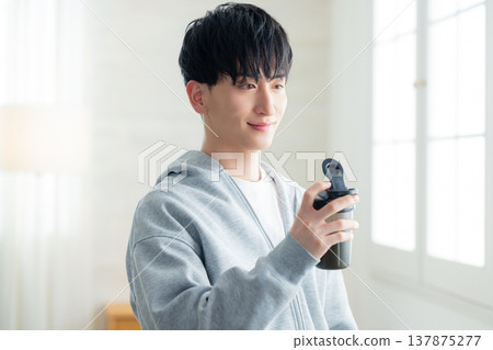 A man holding a protein shaker 137875277