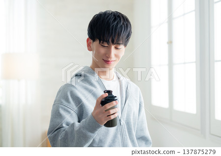 A man holding a protein shaker 137875279