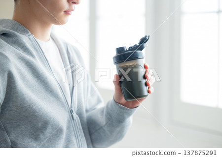 A man holding a protein shaker 137875291