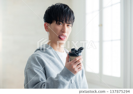 A man holding a protein shaker 137875294