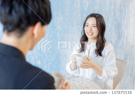 Men and women talking in a cafe Men and women talking in a cafe 137875538