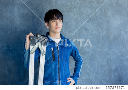 Man in denim work clothes Man in denim work clothes 137875671