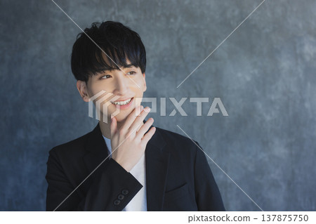 A young man smiling looking at the camera 137875750