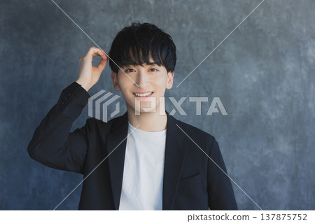 A young man smiling looking at the camera A young man smiling looking at the camera 137875752