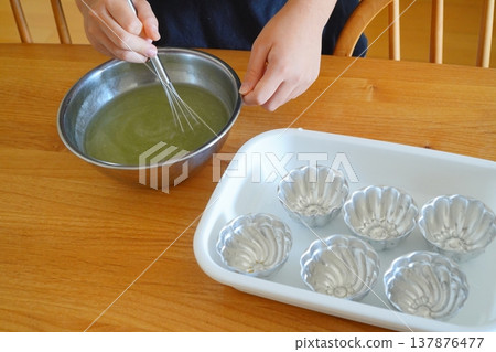 Making homemade jelly with children: a fun family time mixing in a cooking bowl. Making homemade jelly with children: a fun family time mixing in a cooking bowl. 137876477