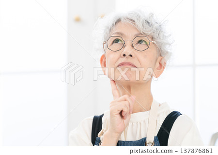 Senior woman standing in the kitchen Cooking image Senior woman standing in the kitchen Cooking image 137876861
