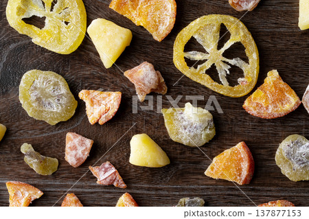 Various kinds of dried fruit against a wood grain background 137877153