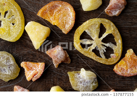 Various kinds of dried fruit against a wood grain background 137877155