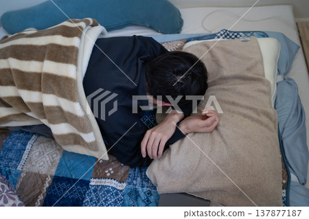 A man sleeping face down in bed A man sleeping face down in bed 137877187