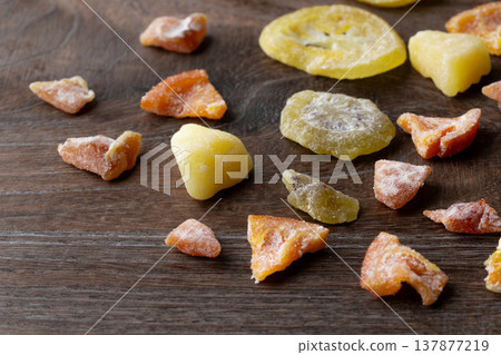 Various kinds of dried fruit against a wood grain background 137877219