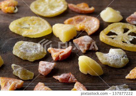 Various kinds of dried fruit against a wood grain background 137877222