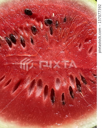 Refreshing Red Melon Piece With Seeds. Bright Red Watermelon Section Displaying Seeds And Glossy Surface 137877392