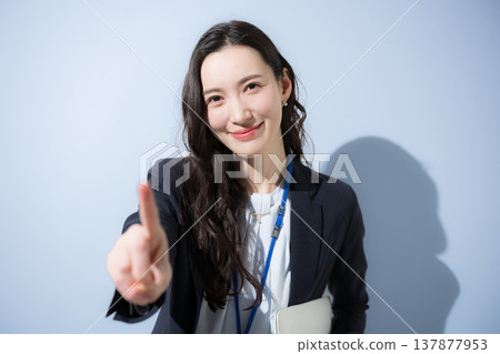 A businesswoman points and uses a CTA to evoke a trustworthy and inviting business image. 137877953