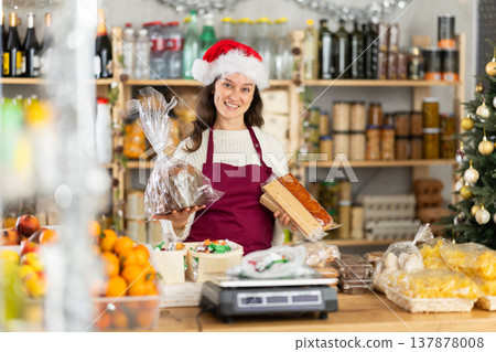 Woman works as salesperson, waiting for customers at store counter, New Year Eve 137878008