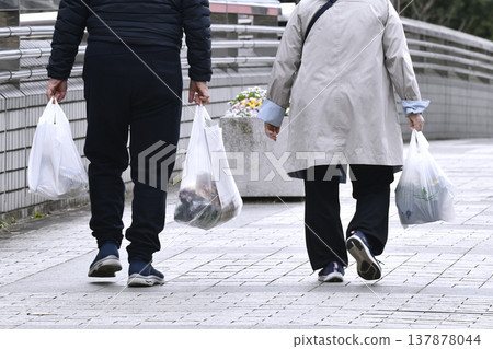 A peaceful scene in the urban landscape of Yokohama, Japan, featuring two people together... an aging society. They seem like kind people... a happy sight... small flowers in a pot. A peaceful scene in the urban landscape of Yokohama, Japan, featuring two people together... an aging society. They seem like kind people... a happy sight... small flowers in a pot. 137878044