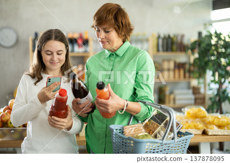 Family chooses juice and scans it on their phone 137878095