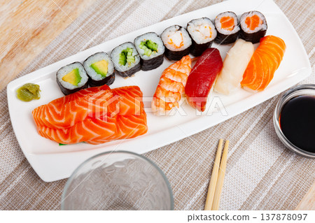On table there portion set with maki, sashimi and nigiri 137878097