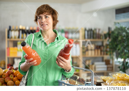 Adult woman choosing juices 137878110