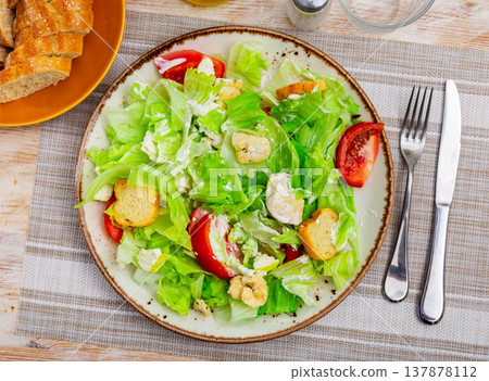 Portion of fresh Caesar salad with tomatoes Portion of fresh Caesar salad with tomatoes 137878112