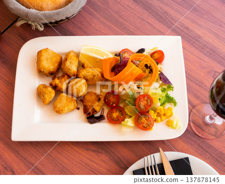 Pieces of marinated dogfish with sliced vegetables on wooden table 137878145