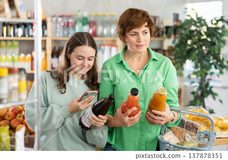 Family chooses juice and scans it on their phone 137878351