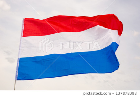Dutch national flag on liberty day against blue sky with clouds. 137878398