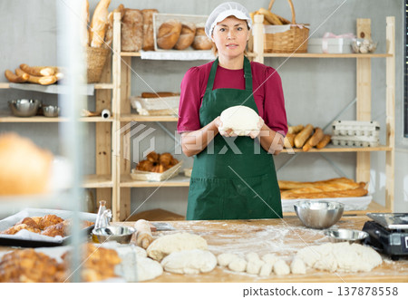 Adult female baker with raw dough 137878558