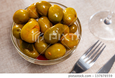 Marinated green olives with pits - typical Spanish tapas closeup Marinated green olives with pits - typical Spanish tapas closeup 137878559