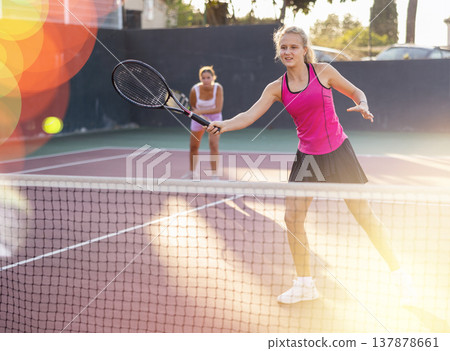 Woman tennis player training on court Woman tennis player training on court 137878661