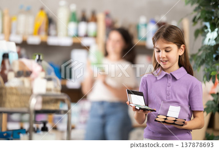 Girl chooses cosmetics in household chemicals store 137878693